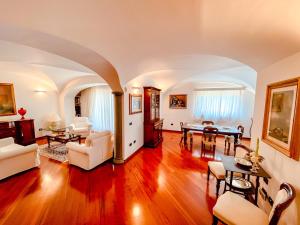 a living room with white furniture and a table at Casa Sterlizia [Olbia] in Olbia
