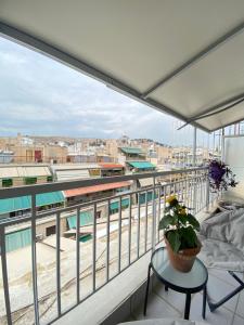 a balcony with a view of a train at Private Apt. Acropolis View. Top Floor. Koukaki in Athens