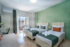 a bedroom with two beds and a dining room at Angela Rooms in Leptokaria +73 photos