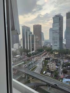 a view from a window of a city with traffic at Amazing Pool By Platinum Suites KLCC in Kuala Lumpur