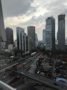 a city with a highway in front of tall buildings at Amazing Pool By Platinum Suites KLCC in Kuala Lumpur