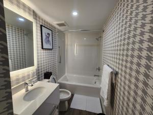 a bathroom with a sink and a toilet and a tub at Superior Shores Hotel BW Signature Collection in Thunder Bay