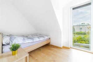 a bedroom with a bed and a large window at Piękny dom blisko lasu i Krakow Airport in Zabierzów