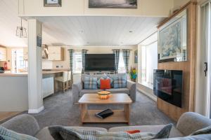 a living room with a couch and a table at Barmouth Bay Holiday Park in Barmouth