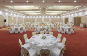 una grande sala banchetti con tavoli e sedie bianchi di Cam Thermal Resort Hotel & Spa a Kızılcahamam