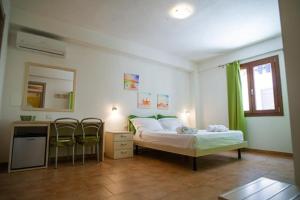 - une chambre avec un lit, un bureau et des chaises dans l'établissement B&B Sulmare, à Marettimo