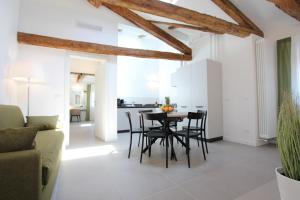 a kitchen and living room with a table and chairs at Residence degli Artisti in Venice