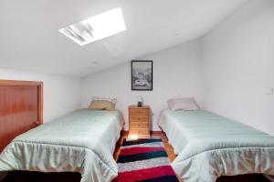 two beds in a room with white walls at Apartamento Cali com Piscina in Apúlia +10 photos