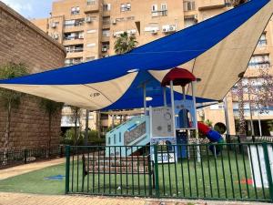 a blue and white canopy over a playground at Oazis 1BR Apt,Central Old Town, Great location in Beer Sheva