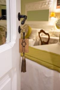 a tassel hanging on a door with a bed at Villa Vicuña Hotel Boutique in Salta