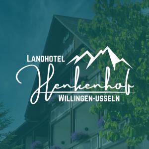 a sign for a hotel with a tree and mountains at Landhotel Henkenhof Willingen in Willingen