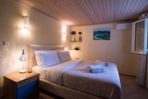 a bedroom with a bed with two towels on it at Petrochori Beach House in Voidokilia