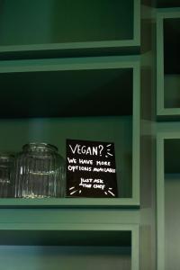 a sign on a shelf in a kitchen at Conscious Hotel Vondelpark in Amsterdam
