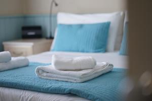 a bed with two folded towels on top of it at Nutcroft, Cowes in Cowes