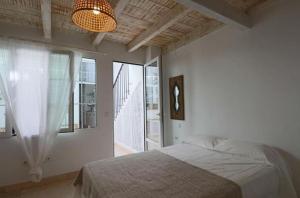 a bedroom with a bed and a large window at Apartamentos Castillo Quince in Cartaya