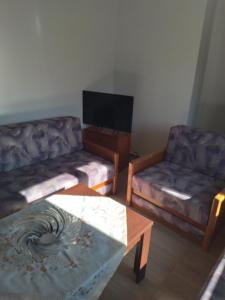 a living room with two couches and a coffee table at Acropolis view apartment in Limenas