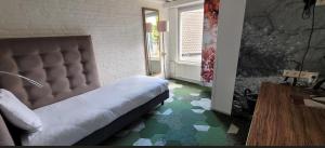 a bedroom with a bed sitting on a green floor at Landgoed Huize Bergen Den Bosch - Vught in Den Bosch