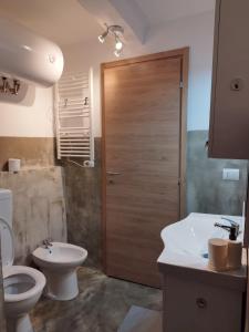 a bathroom with a toilet and a sink and a shower at The First Luccoli Garibaldi Rolli in Genova +38 photos