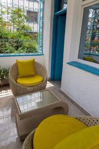a patio with chairs and a table and a window at 2 bedroom entire Apt Fully air conditioned-MSA City centre in Mombasa