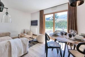 a living room with a table and a couch at La Collection - Le Village in Saint-Gervais-les-Bains