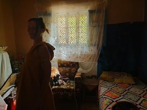 a woman standing in front of a bedroom with a window at Humansofupperegyt in Luxor