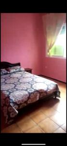 a bedroom with a bed in a room with a window at مهدية تجزئة العامرية in Kenitra