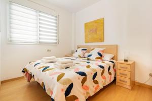 een slaapkamer met een groot bed en een raam bij Apartamento Welcs EMP 060 con Terraza y Piscina in Empuriabrava