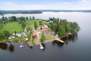 an aerial view of a house on an island in the water at Holiday Lakefront house in Björköby