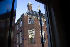 a street sign in front of a brick building at SWEETS - Walter Süskindbrug in Amsterdam
