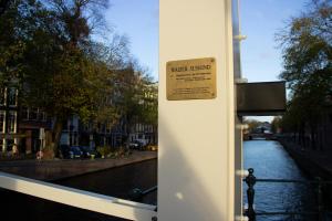 a sign on the side of a building next to a river at SWEETS - Walter Süskindbrug in Amsterdam +4 photos