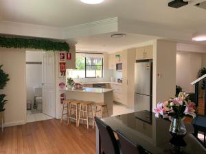 a kitchen and dining room with a table and chairs at Comfy place with all in Revesby