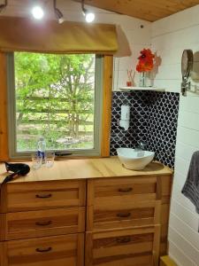 a bathroom with a sink and a window at Mulberry Cottage Farm in Wyboston