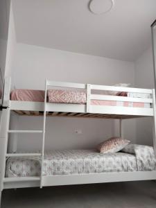 a bunk bed room with two bunk beds at MARiPEP Playa Vinaròs in Vinaròs