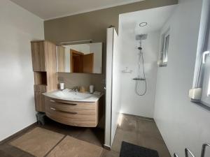a bathroom with a sink and a mirror at Apartment Katharina in Klagenfurt +7 photos