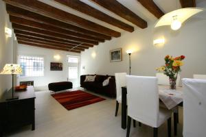 a living room with a table and a couch at City Apartments Salute-Accademia in Venice