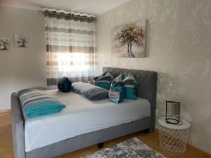 a couch with pillows in a room with a window at Apartment Katharina in Klagenfurt