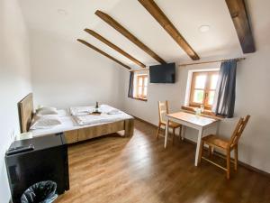 a bedroom with a bed and a table and chairs at Boutique Rooms & Winery Žorž in Vipava