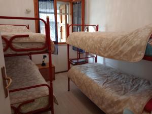 a room with three bunk beds and a window at Casa a Cervia, via Gargano 14 in Cervia