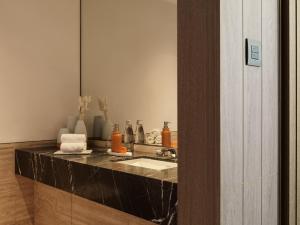 a bathroom with a sink and a mirror at City of Dreams Mediterranean - Integrated Resort, Casino & Entertainment in Limassol
