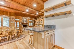 a kitchen and dining room with a table and chairs at Papa Bear Cabin in Welches