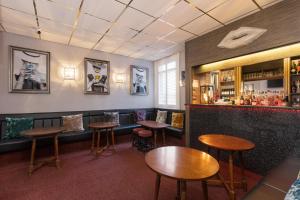 a bar with wooden tables and stools in a room at Adelaide Lodge - Town Centre - Opposite Winter Gardens in Blackpool