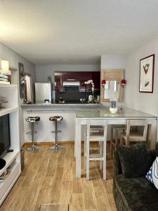 a living room with a table and a kitchen at Résidence Saint Tropez in Saint-Tropez