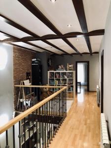 a living room with a coffered ceiling and a staircase at La Porticada Boutique House in Morella