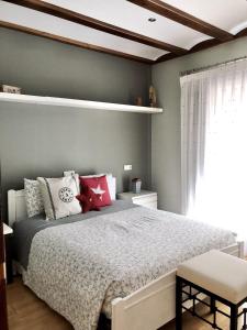 a bedroom with a large bed and a window at La Porticada Boutique House in Morella