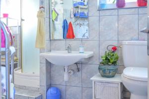 a bathroom with a sink and a toilet at Bingo Apartment in Split +38 photos