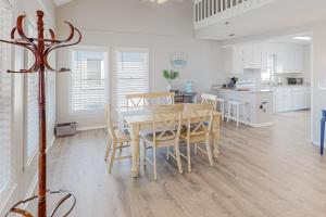 a kitchen and dining room with a table and chairs at HB261 Rosie's Rendezvous in Holden Beach