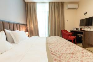 a hotel room with a bed and a desk at Elea Old Tbilisi Hotel in Tbilisi City