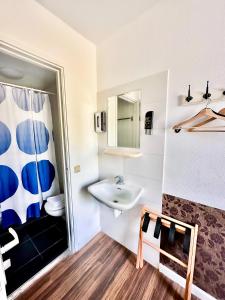 a bathroom with a sink and a mirror at Hotel Amsterdam Inn in Amsterdam