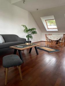 a living room with a couch and a table at Landhaus am Loh in Wesel