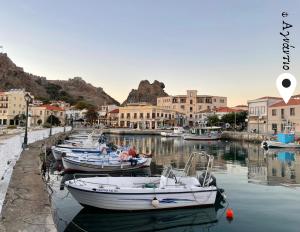a group of boats are docked in a harbor at «ΑΓΝΑΝΤΙΟ l» Δωμάτιο με μοναδική θέα! in Myrina